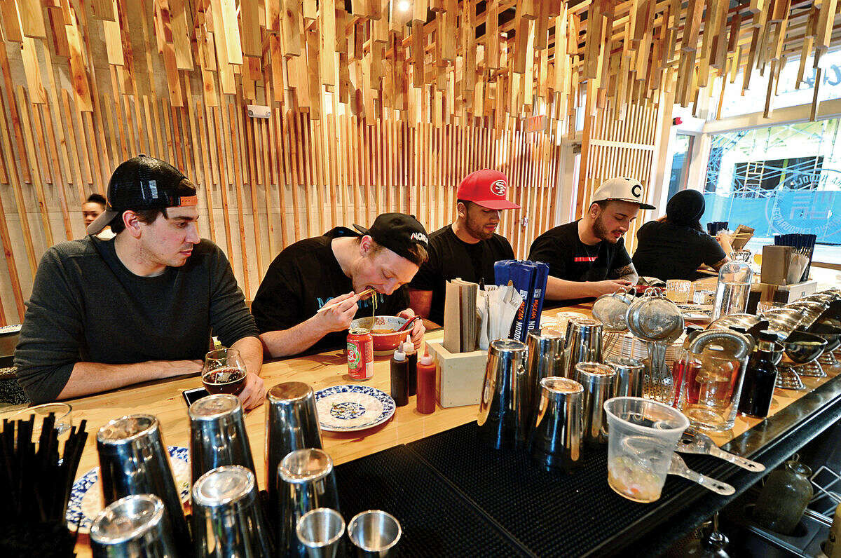 Hour photo / Erik Trautmann Patrons slurp through their meals at the new Mecha noodle bar restaurant in SoNo.