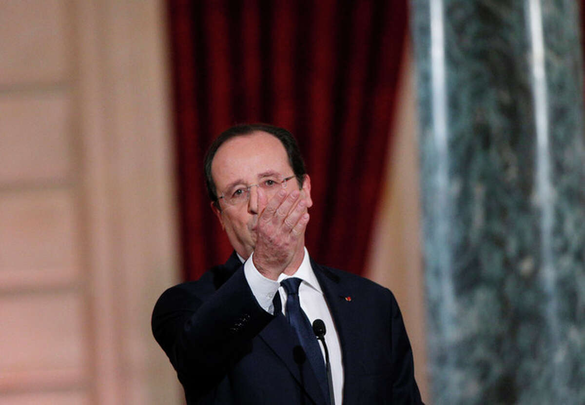 French President Francois Hollande addresses a reporter during his annual news conference, Tuesday, Jan.14, 2014 at the Elysee Palace in Paris. Hollande is promising to cut 50 billion euros in public spending over 2015-2017 to try to improve the indebted economy. Hollande, a Socialist, came to office in 2012 on pledges to avoid the painful austerity measures carried out by neighboring Spain and Italy. But France?’s economy has suffered two recessions in recent years and growth is forecast at an anemic 0.2 percent in 2013. (AP Photo/Christophe Ena)