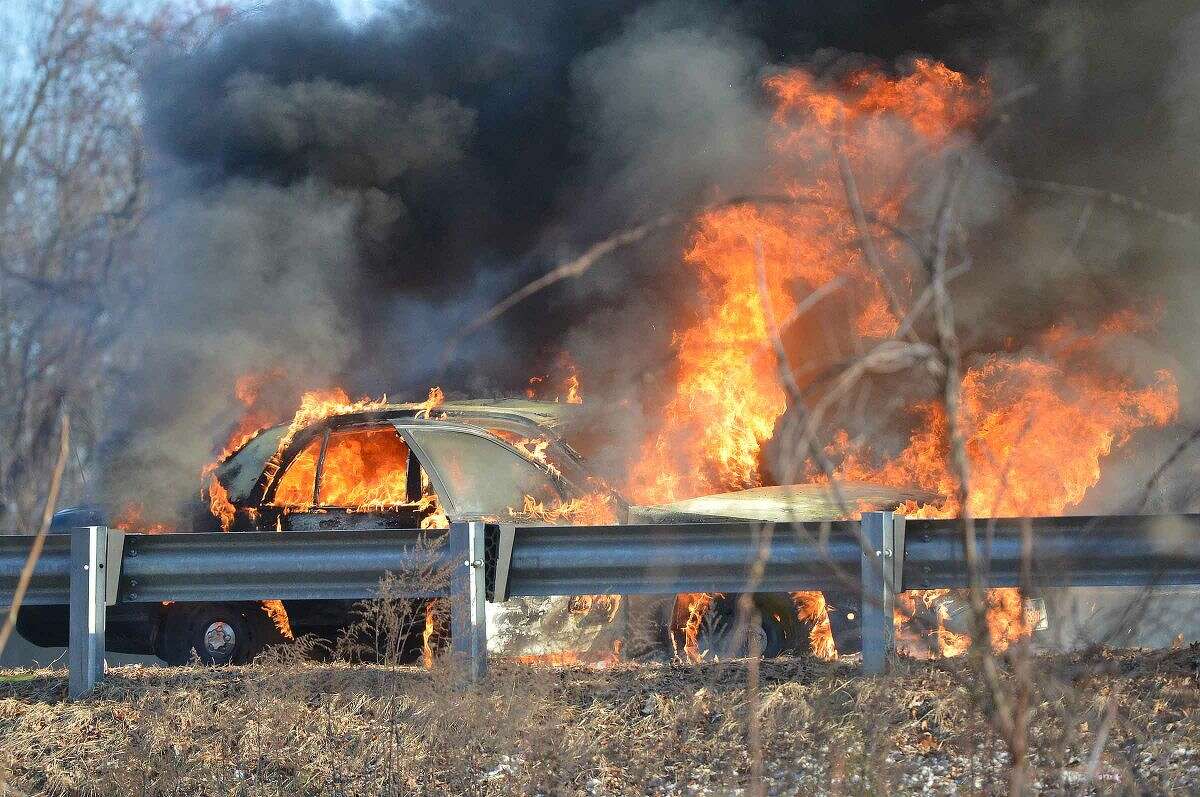Hour Photo/Alex von Kleydorff A taxi burns on the soutbound side of I 95 at approx 3:30 pm on Thursday