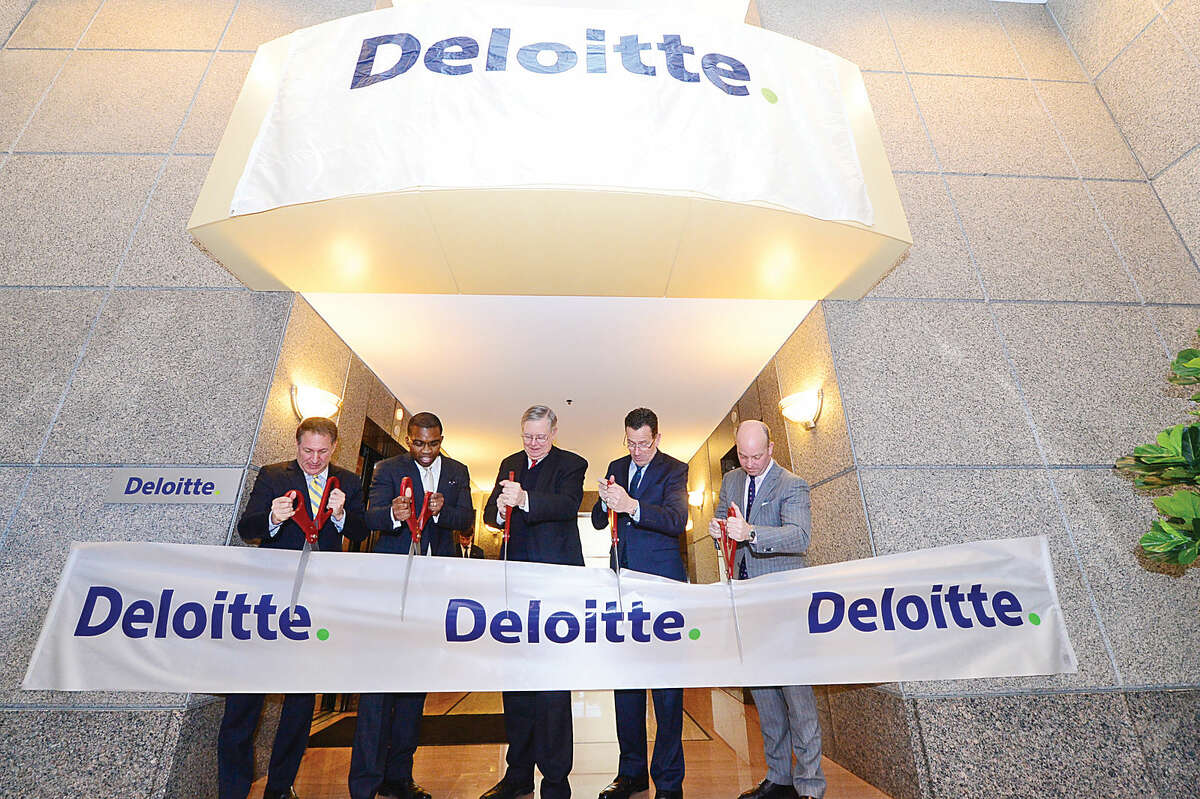From left to right: Building and Land Technology CEO Carl Kuehner, Deloitte partner Kevin Richards, Mayor David Martin, Gov. Dannel P. Malloy, and Deloitte managing partner Steve Gallucci, cut the ribbon at Deloitte’s new headquarters at the BLT Financial Centre on East Main Street in Stamford Tuesday.