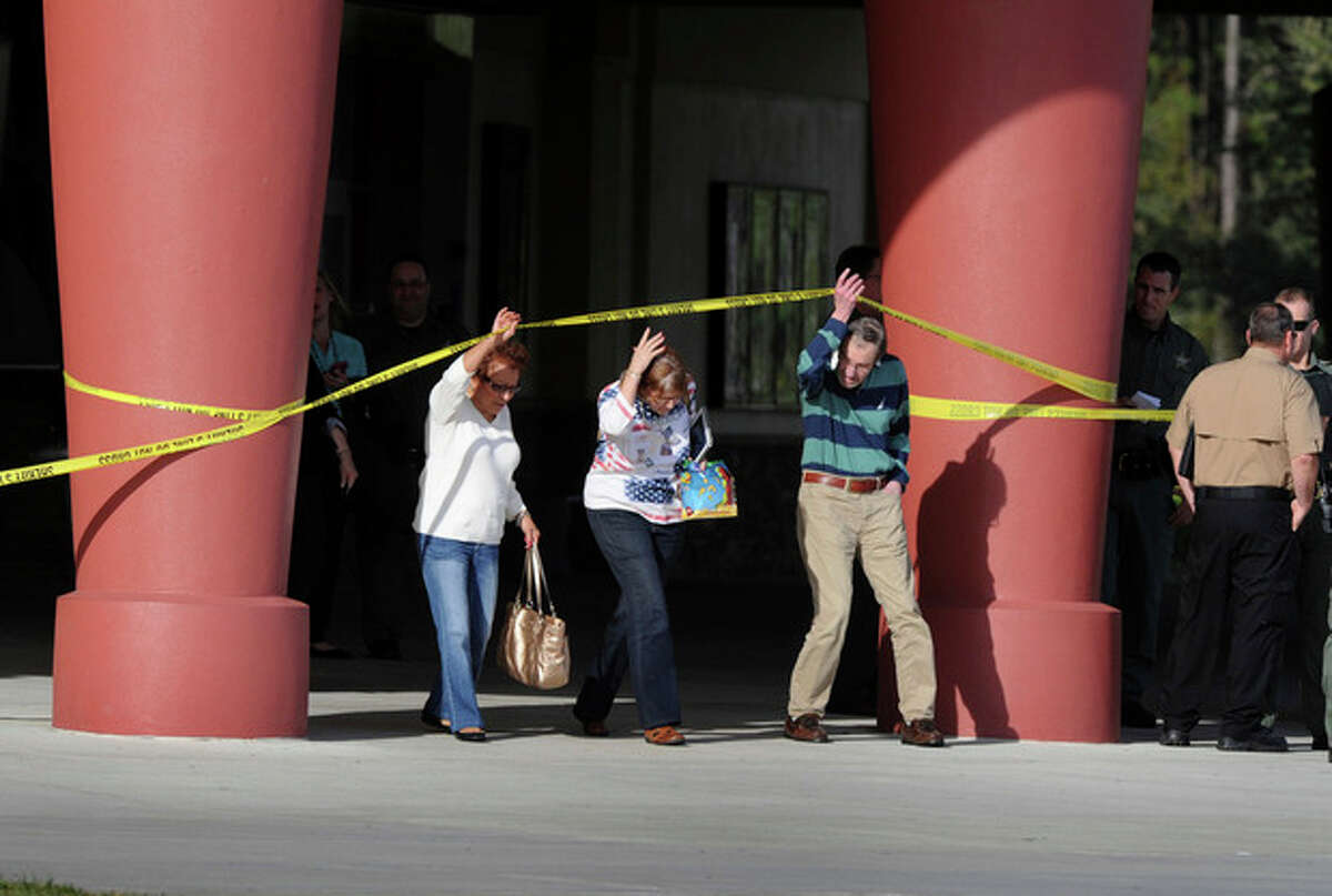Patrons leave Cobb theater after a shooting Monday, Jan. 13, 2014, in Wesley Chapel, Fla. Authorities say a retired Tampa police officer has been charged with fatally shooting a man during an argument over cellphone use at the theater. (AP Photo/The Tampa Tribune, Cliff Mcbride)