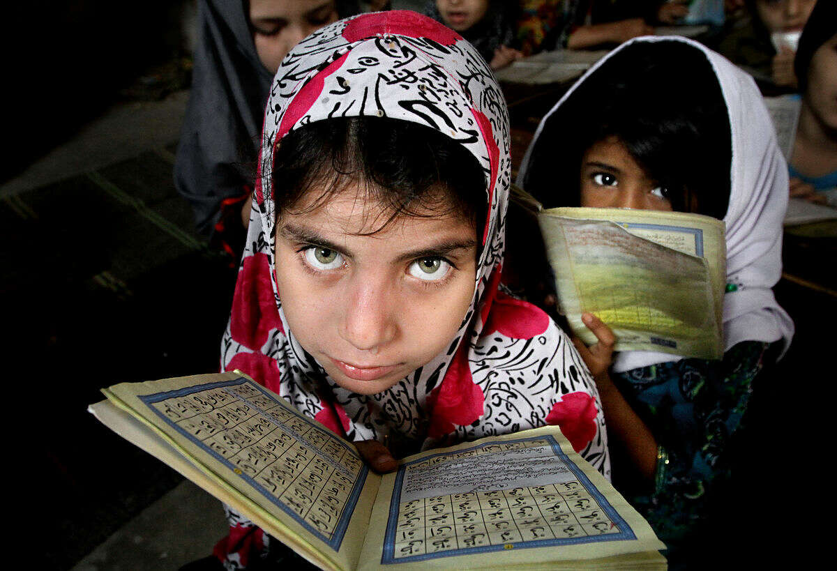 Pakistani girls read the Quran, Islam's holy book, at a local madrassa or seminary in Karachi, Pakistan, Wednesday, Jan. 27, 2016. (AP Photo/Fareed Khan)
