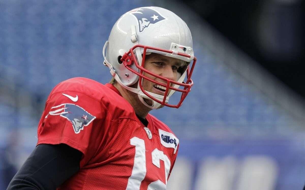 New England Patriots quarterback Tom Brady (12) smiles as he runs through a drill during NFL football practice at Gillette Stadium in Foxborough, Mass., Wednesday, Jan. 14, 2015. The Patriots face the Indianapolis Colts in the AFC Championship game on Sunday. (AP Photo/Charles Krupa)