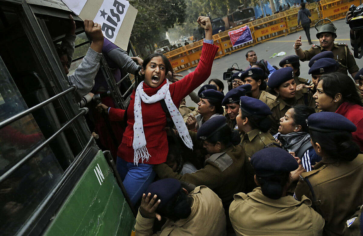 An Indian student shouts slogans demanding resignation of Indian education minister as she is detained by police during a protest against the death of student Rohith Vemula in New Delhi, India, Wednesday, Jan. 27, 2016. The students were protesting the death of Vemula, who, along with 4 others, was barred from using some facilities at his university in the southern tech-hub of Hyderabad. The protesters accused Hyderabad University's vice chancellor along with two federal ministers of unfairly demanding punishment for the five lower-caste students after they clashed last year with a group of students supporting the governing Hindu nationalist party. (AP Photo/Altaf Qadri)