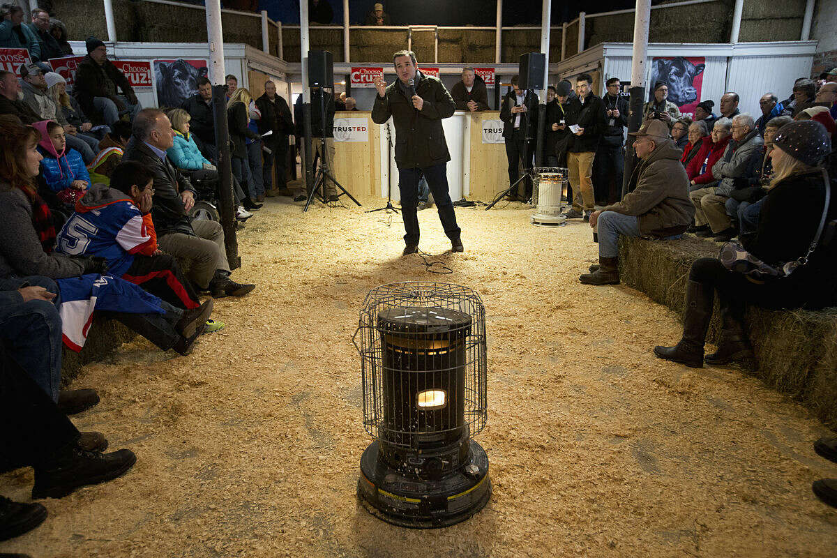 A space heater stands in front of supporters as Republican presidential candidate, Sen. Ted Cruz, R-Texas speaks at a campaign event at High Point Bulls Oswald Barn, Tuesday, Jan. 26, 2016, in Osceola, Iowa. (AP Photo/Jae C. Hong)
