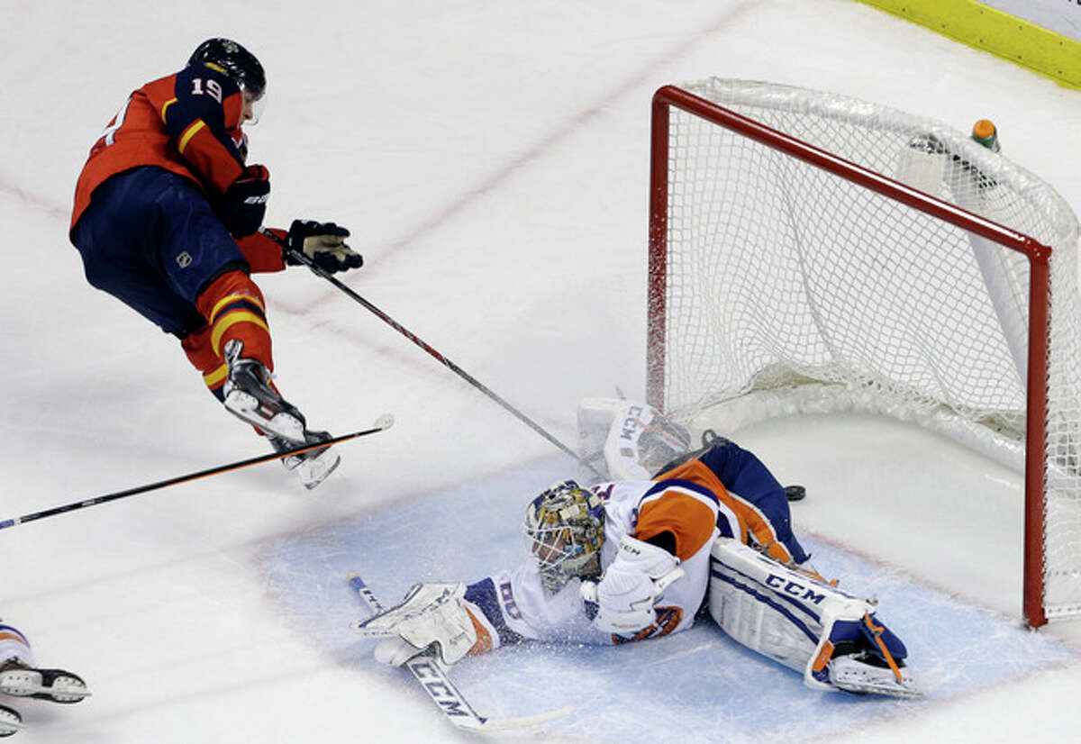 Florida Panthers' Scottie Upshall (19) scores a goal against New York Islanders goalie Kevin Poulin during the second period of an NHL hockey game, Tuesday, Jan. 14, 2014, in Sunrise, Fla. (AP Photo/Lynne Sladky)