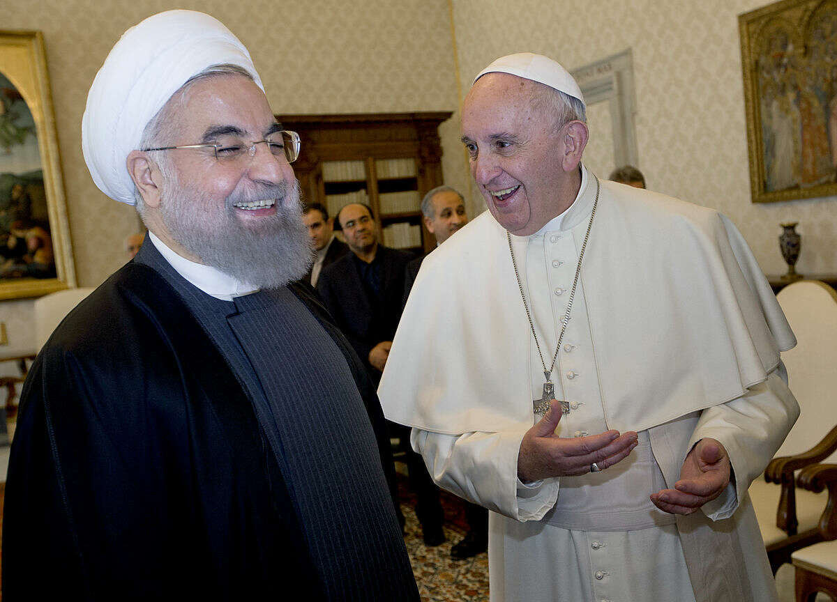 Pope Francis and Iranian President Hassan Rouhani, left, share a laugh during their private audience at the Vatican,Tuesday, Jan. 26, 2016. Iran’s president has paid a call on Pope Francis at the Vatican during a European visit aimed at positioning Tehran as a potential top player in efforts to resolve Middle East conflicts, including Syria’s civil war. (AP Photo/Andrew Medichini, Pool)