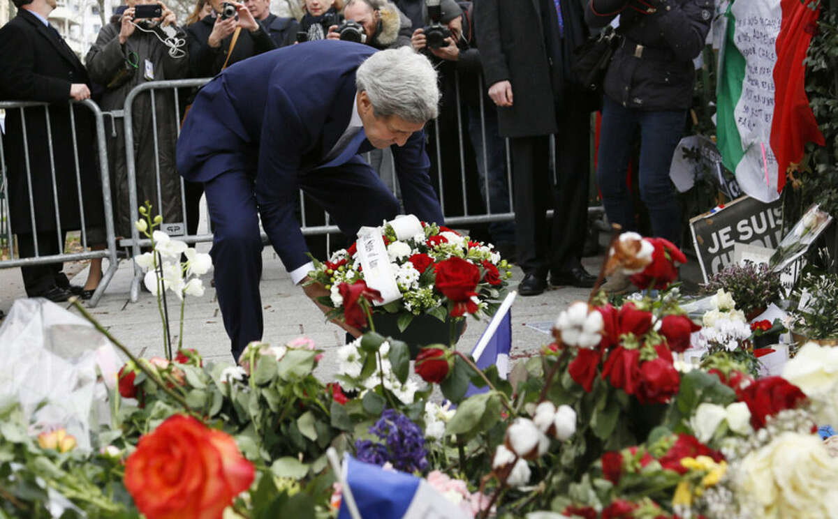 U.S. Secretary of State John Kerry lays a bouquet of flowers at a memorial site after the terrorist attacks in Paris, Friday, Jan. 16, 2015. U.S. Secretary of State John Kerry paid his respects Friday to the victims of last week's terrorist attacks in Paris in a show of American solidarity with the French people. (AP Photo/Rick Wilking, Pool)