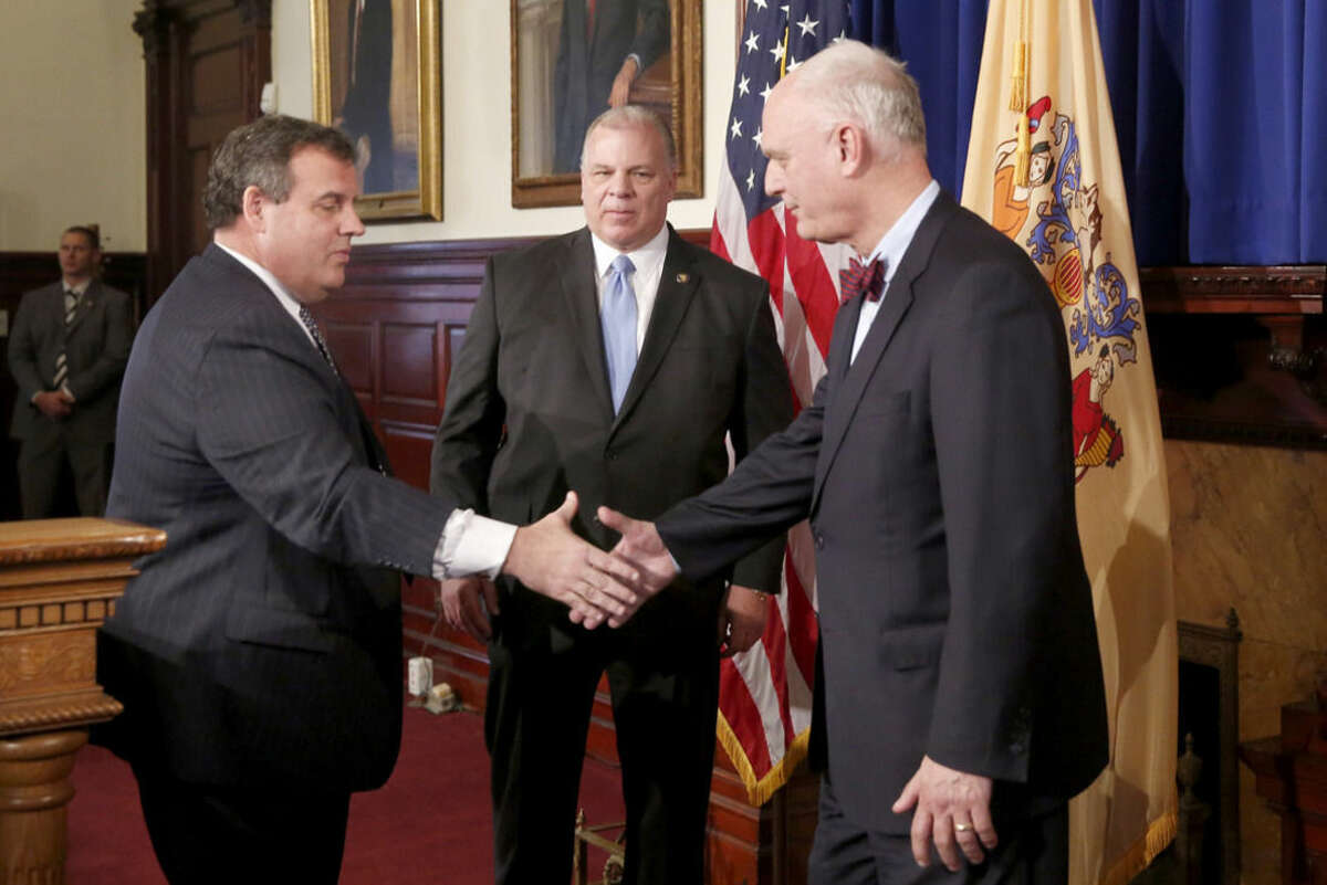 Senate President Stephen Sweeney, center, watches New Jersey Gov. Chris Christie, left, and Atlantic City Mayor Don Guardian shake hands at the end of the press conference in Trenton, N.J., Tuesday, Jan. 26, 2016. Christie said Tuesday the state will assume vast control over Atlantic City's finances and decision-making, saying the seaside gambling resort is incapable of getting its finances together after years of overspending. (Aristide Economopoulos/NJ Advance Media via AP) MANDATORY CREDIT