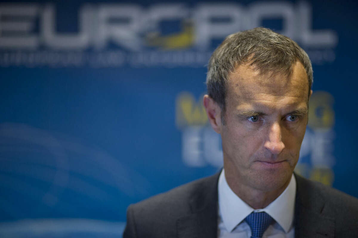 The head of the European police agency, Europol, Rob Wainwright, listens to questions during an interview in The Hague, Netherlands, Friday, Jan. 16, 2015. French and German authorities arrested at least 12 people Friday suspected of links to the Islamic State group and a Paris train station was evacuated, with Europe on alert for new potential terrorist attacks. The police raids came the morning after Belgian authorities moved swiftly to pre-empt what they called a major impending attack, killing two suspects in a firefight and arresting a third in a vast anti-terrorism sweep that stretched into the night. (AP Photo/Peter Dejong)