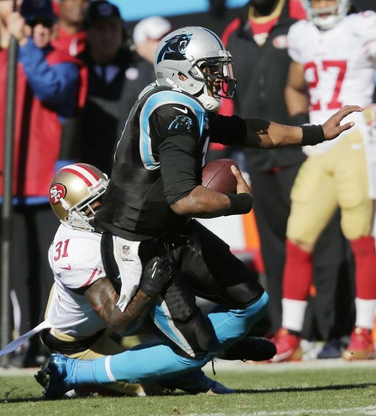 San Francisco 49ers strong safety Donte Whitner (31) tackles Carolina Panthers quarterback Cam Newton (1) during the first half of a divisional playoff NFL football game, Sunday, Jan. 12, 2014, in Charlotte, N.C. (AP Photo/Chuck Burton)