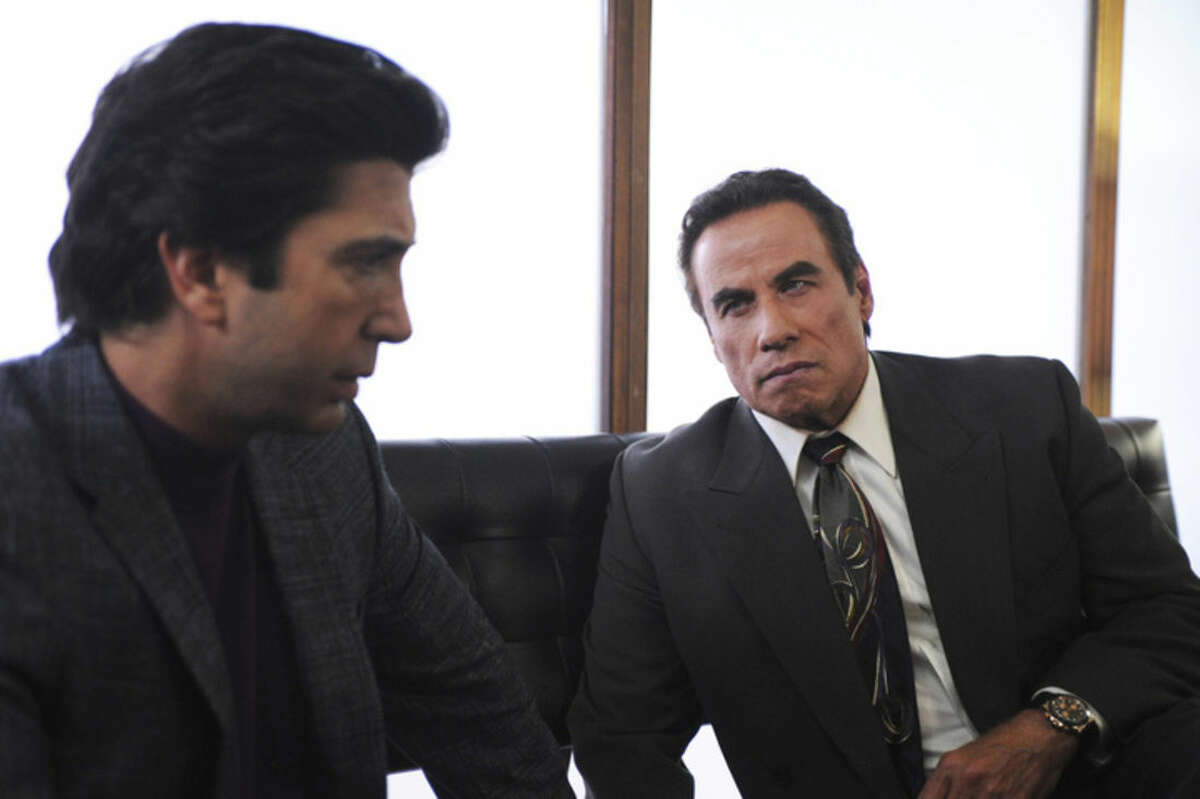 In this image released by FX, David Schwimmer portrays Robert Kardashian, left, and John Travolta portrays Robert Shapiro, in a scene from "The People v. O.J. Simpson: American Crime Story," a 10-part series debuting Tuesday, Feb. 2, at 10 p.m. EST Tuesday. (Ray Mickshaw/FX via AP)