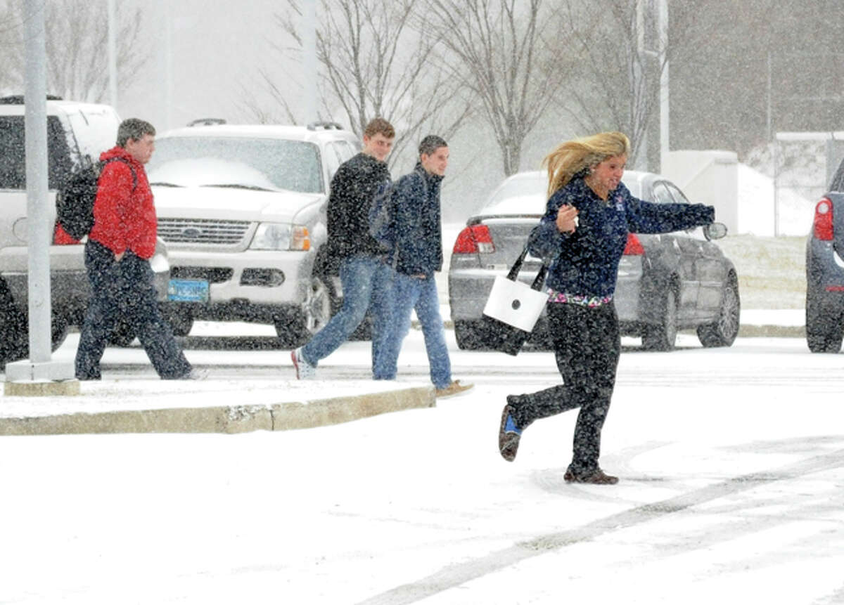 Studenst break for thier cars for the early dismissal Tuesday at Brien MvMahon High School. Hour photo/Matthew Vinci