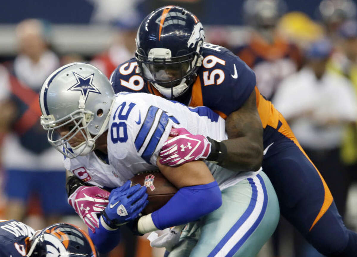 FILE - In this Oct. 6, 2013, file photo, Dallas Cowboys tight end Jason Witten (82) is stopped by Denver Broncos linebacker Danny Trevathan (59) during the first quarter of an NFL football game in Arlington, Texas. His season began in embarrassing fashion with a fumble at the goal line, but Trevathan promised to learn from his mistake and move on. He's done just that, leading the Broncos in tackles and helping the defense withstand the loss of five starters to injuries to surge into the Super Bowl.(AP Photo/Tony Gutierrez, File)