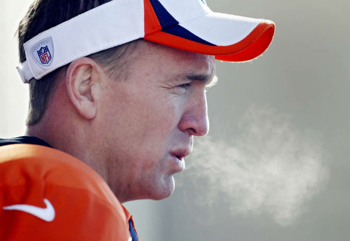 The breath of Denver Broncos quarterback Peyton Manning exhales as he talks to the media after NFL football practice at the team's training facility in Englewood, Colo., on Thursday, Jan. 23, 2014. The Broncos are scheduled to play the Seattle Seahawks in Super Bowl XLVIII on Feb. 2. (AP Photo/Ed Andrieski)