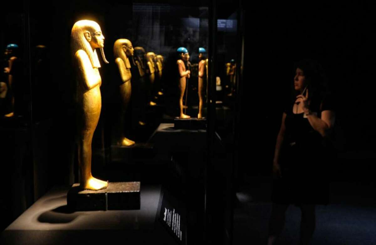 NEW YORK - APRIL 21: A woman looks at objects on display during the press preview of the "Tutankhamun And The Golden Age Of The Pharaohs" exhibition at the Discovery Times Square Exposition Center on April 21, 2010 in New York City. (Photo by Jemal Countess/Getty Images)