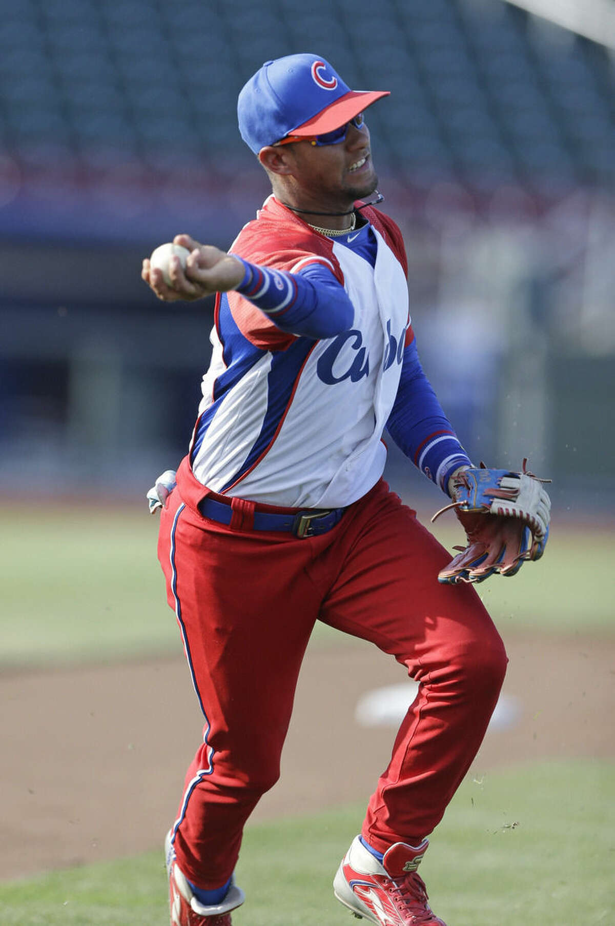 FILE - In this July 19, 2013 file photo, Cuba third baseman Yulieski Gourriel warms up prior to an exhibition baseball game against the United States in Papillion, Neb. A baseball official in the Dominican Republic said on Monday, Feb. 8, 2016, that Gourriel has abandoned his team at the close of the annual Caribbean series. The 31-year-old was with his younger brother, Lourdes, also a highly sought player. (AP Photo/Nati Harnik, File)