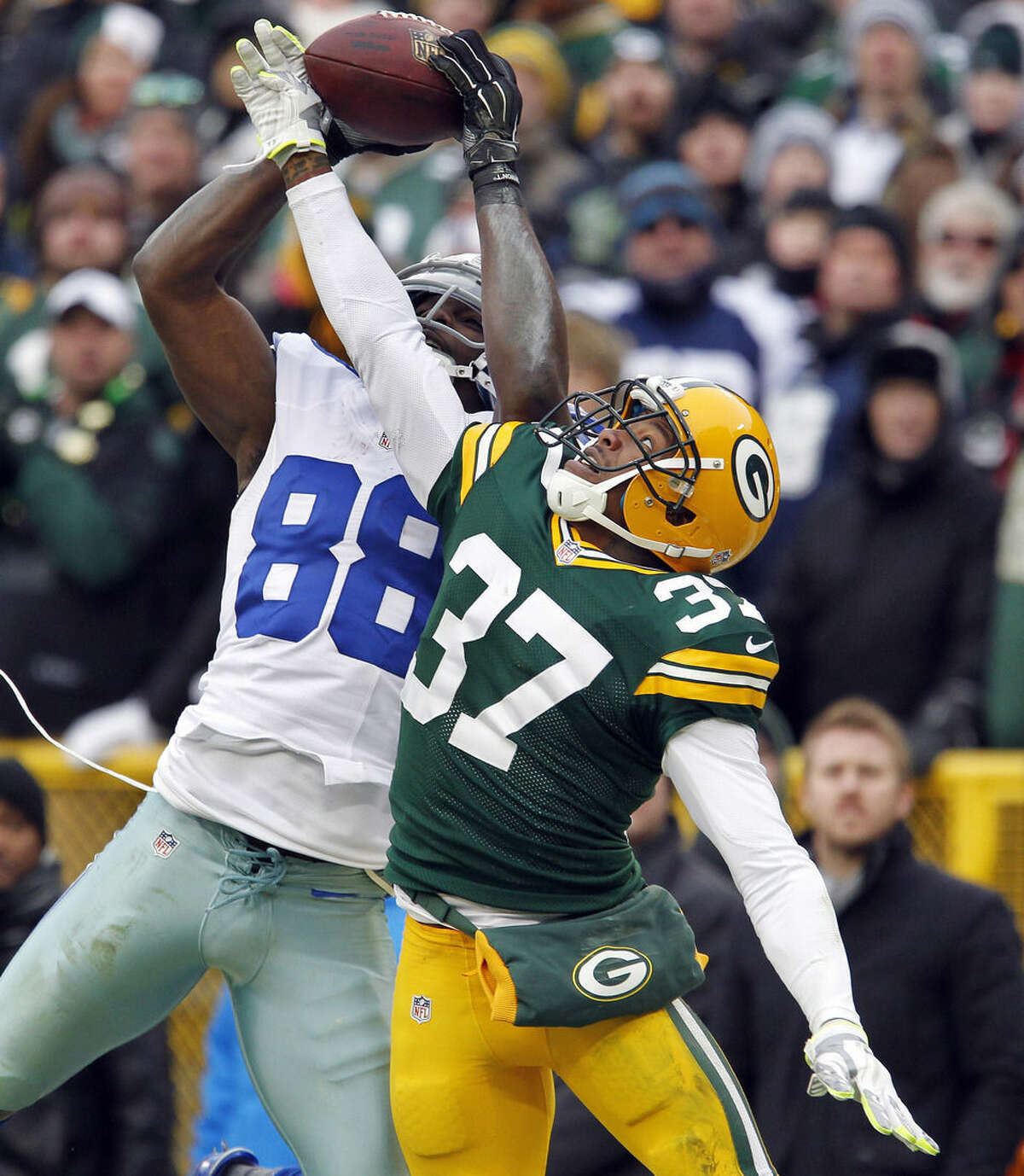 ADVANCE FOR WEEKEND EDITION, JAN. 31-FEB. 1 - FILE - In this Jan. 11, 2015, file photo, Dallas Cowboys wide receiver Dez Bryant (88) catches a pass against Green Bay Packers cornerback Sam Shields (37) during the second half of an NFL divisional playoff football game in Green Bay, Wis. The play was reversed. Concussions, domestic abuse arrests, questionable officiating and another cheating controversy. And yet, the league still popular as ever with ratings and revenue streams that make other leagues jealous. (AP Photo/Matt Ludtke, File)