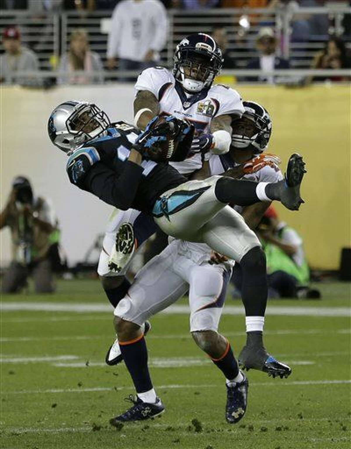 Carolina Panthers’ Corey Brown (10) catches a pass in front of Denver Broncos’ T.J. Ward (43) and Aqib Talib (21) during the second half of the NFL Super Bowl 50 football game Sunday, Feb. 7, 2016, in Santa Clara, Calif. (AP Photo/Gregory Bull)