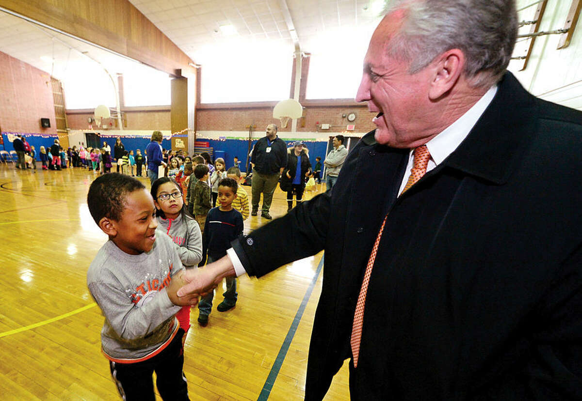 Hour photo / Erik Trautmann Kendall Elementary School students line up to shake the hand of Norwalk mayor, Harry Rilling, following the school's Great Kindness Challenge assembly Tuesday that culminated a week of events that are part of Kendall's anti-bullying and positive citizenship program.
