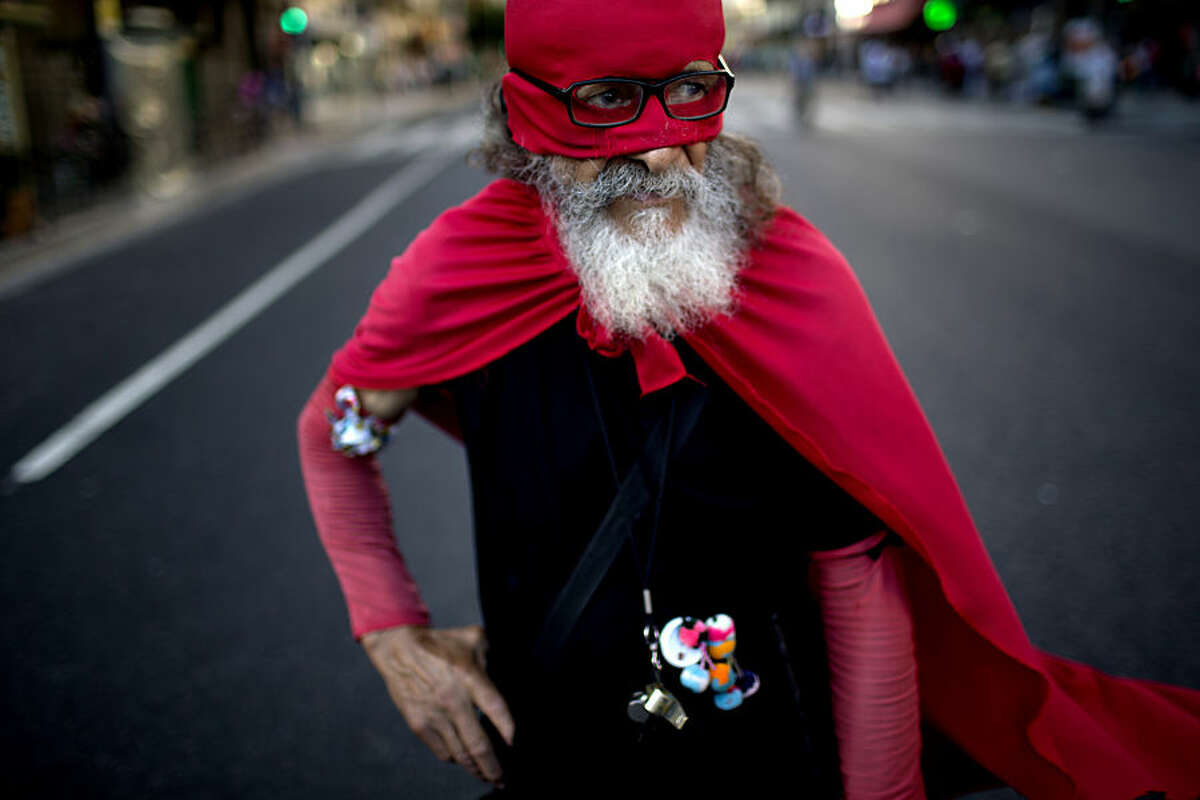 Esteban Florentin, 72, who says he is dressed as a red ant, poses for a portrait during a march for justice and against impunity in the case of the mysterious death of late prosecutor Alberto Nisman, in Buenos Aires, Argentina, Wednesday, Feb. 4, 2015. Investigators examining the death of Nisman, who accused Argentine President Cristina Fernandez of agreeing to shield the alleged masterminds of a 1994 terror bombing, said Tuesday, they have found a draft document he wrote requesting her arrest. (AP Photo/Rodrigo Abd)
