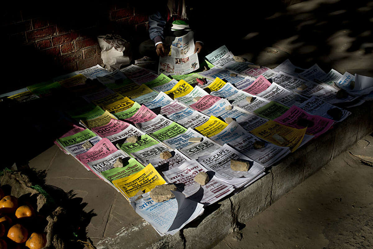 Employment news leaflets and announcements for government jobs are displayed for sale on a street in New Delhi, India, Thursday, Feb. 5, 2015. Government jobs are still the aspired form of employment for many in India because of the stability it provides and most of these jobs require a rigorous competitive examination process. (AP Photo/Bernat Armangue)