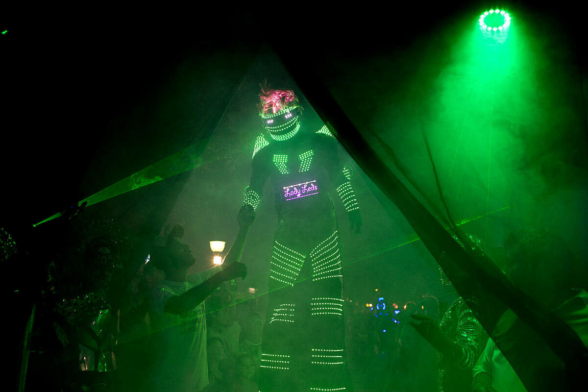 In this Feb. 12, 2016 photo, an alien enthusiast in an illuminated costume arrives for a parade at the annual Alien Festival in Capilla del Monte, Cordoba, Argentina, the site of an alleged UFO sighting 30 years ago. Thousands of earthlings gathered for the festival in this central Argentine town which has become a global hot spot for UFO sightings. (AP Photo/Natacha Pisarenko)