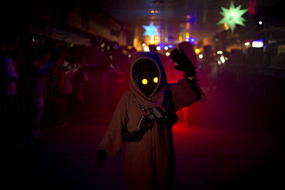 In this Feb. 14, 2016 photo, a youth sporting a Star Wars costume parades at the annual Alien Festival in Capilla del Monte, Cordoba, Argentina, the site of an alleged UFO sighting 30 years ago. Thousands of earthlings gathered for the festival in this central Argentine town which has become a global hot spot for UFO sightings. (AP Photo/Natacha Pisarenko)