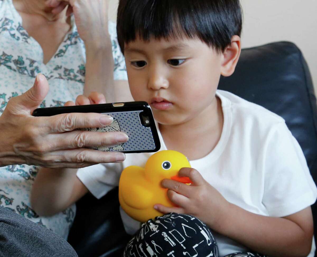Yui Matusmoto, 4, plays with Edwin the Duck, a digital duck toy, in the living room of his home in Tokyo.