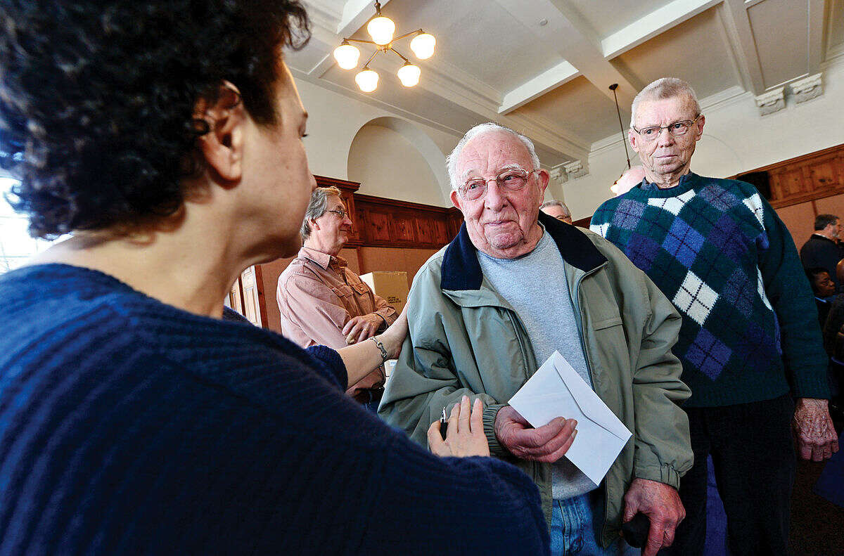 Hour photo / Erik Trautmann Norwalk resident Ray Flewellen gets assistamce from Paula Kyriakides on the Norwalk Tax Assessors Office during the Norwalk Senior Tax Relief Workshop in the City Hall Community Room Saturday.