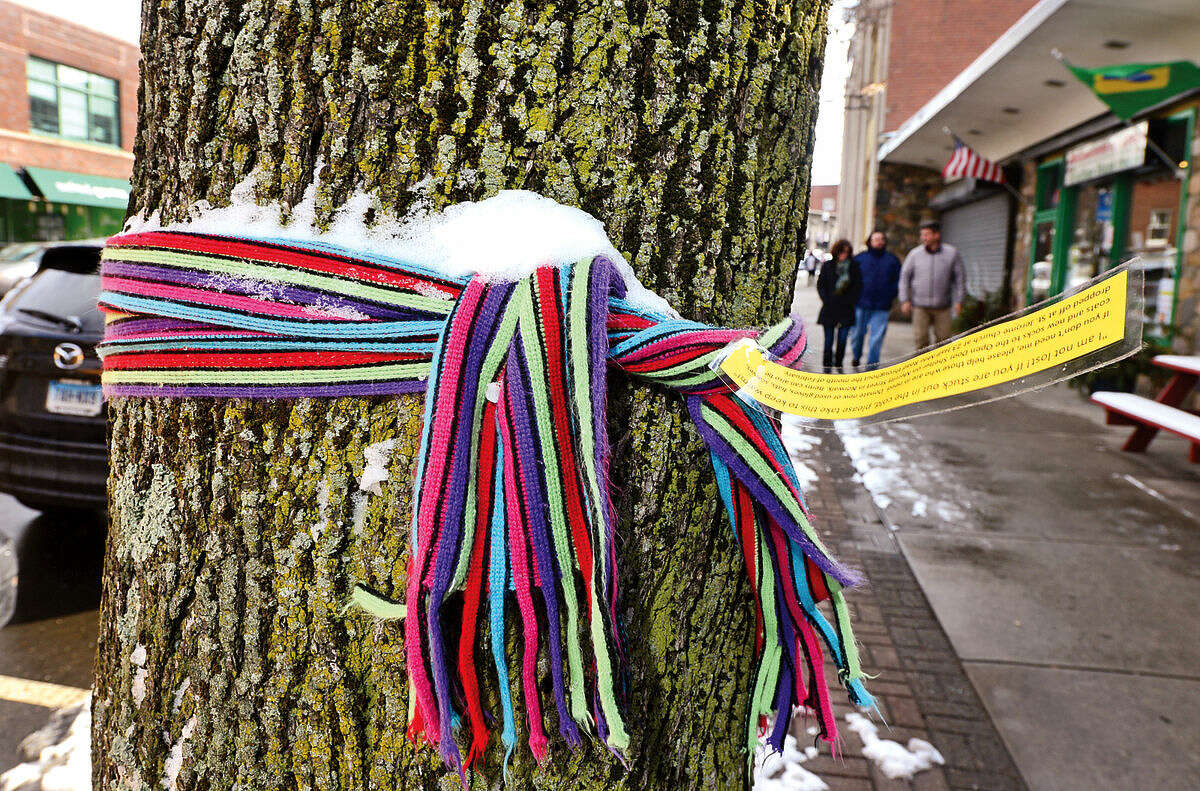 Hour photo / Erik Trautmann A scarve is tied on a pole on North Main St in South Norwalk with an note offering it to those who may need it. The St Jerome Youth Group tied the scarves around the city in an effort to draw attention to homelessness in Norwalk.