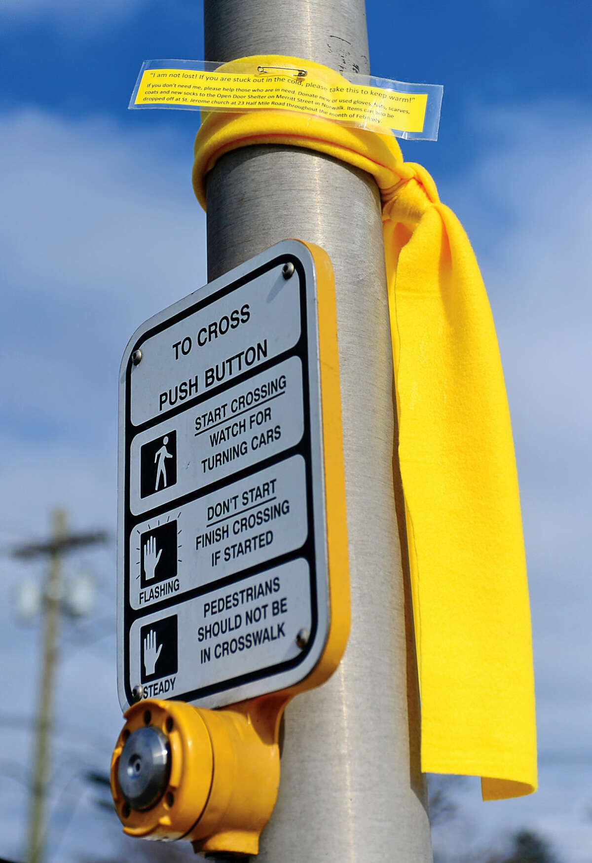 Hour photo / Erik Trautmann A scarve is tied on a pole on East Ave in Norwalk with an note offering it to those who may need it. The St Jerome Youth Group tied the scarves around the city in an effort to draw attention to homelessness in Norwalk.