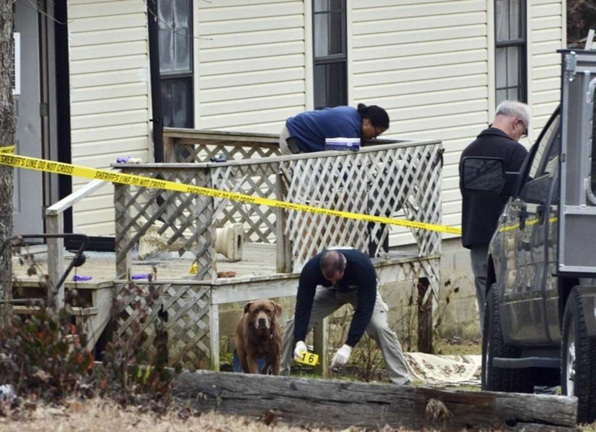 Officers investigate the scene of a shooting near Iuka, Miss., Saturday, Feb. 20, 2016. Multiple law enforcement officers were injured after an hourslong standoff in rural north Mississippi ended in fatal gunfire, authorities said. (AP Photo/Michael H. Miller)