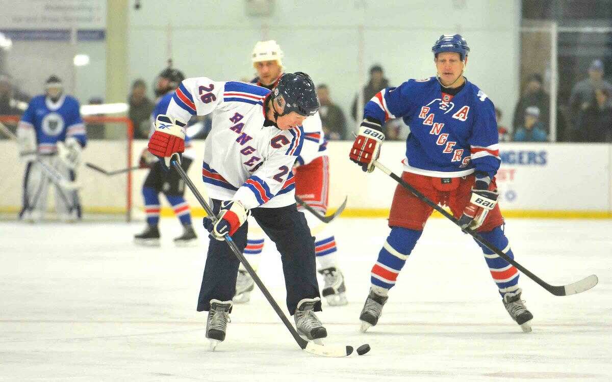 Hour Photo/Alex von Kleydorff Former player, Dave Maloney moves the puck during the NY Rangers 'Assist' program game to benefit Hockey in Norwalk