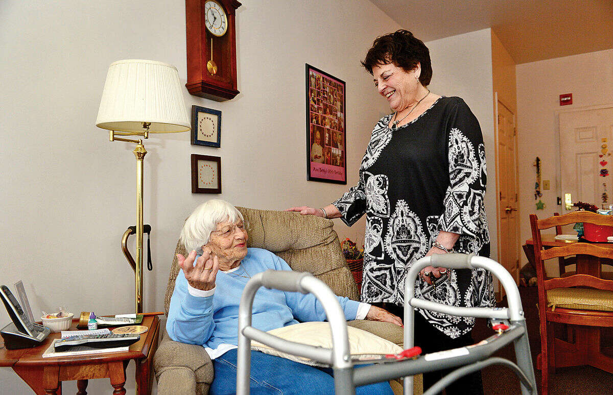 Hour photo / Erik Trautmann Resident Betty Mayer chats with Mary Windt who is celebrating 20 years as the Executive Director of Under One Roof and The Marvin senior housing facility.