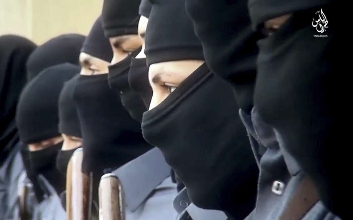 This image made from video posted online Sunday, Dec. 20, 2015, by supporters of the Tripoli Province of the Islamic State (IS) in Libya on a social media site, shows training of it's "Islamic police" in Sirte, Libya. American warplanes struck multiple targets in Libya overnight, hitting what was apparently an Islamic State training camp and a senior extremist leader, a U.S. official said Friday, Feb. 19, 2016.(militant video via AP)