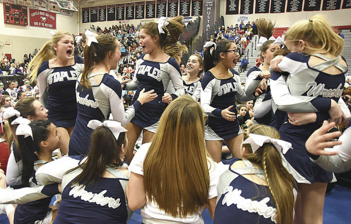 Hour photo/John Nash The Staples High School cheerleading team explodes into a frenzy as they were announced as runners-up during Saturday's FCIAC cheerleading championship competition at Fairfield Warde High School.