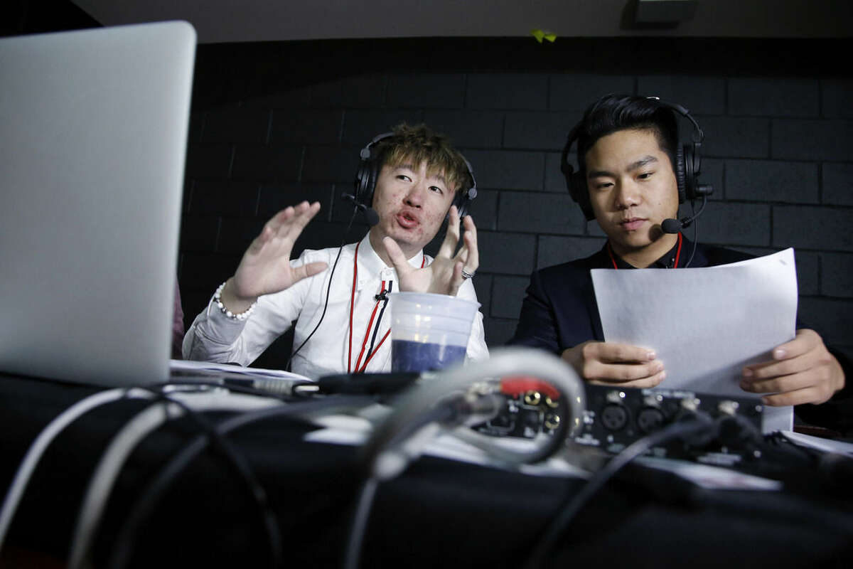 In this Wednesday, Feb. 17, 2016 photo, Temple students Javi Yuan, left, and James Yuan prepare for a broadcast before an NCAA college basketball game between Temple and Villanova, in Philadelphia. The two Chinese students are broadcasting a live audio stream of home Temple basketball games in Mandarin. The pair, who beat out 18 other hopefuls on campus, say basketball is one way to help bridge the cultural gap with their American peers. (AP Photo/Matt Slocum)