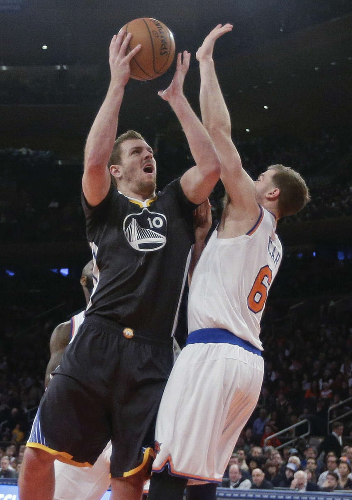 Golden State Warriors' David Lee (10) shoots over New York Knicks' Travis Wear (6) during the first half of an NBA basketball game Saturday, Feb. 7, 2015, in New York. (AP Photo/Frank Franklin II)