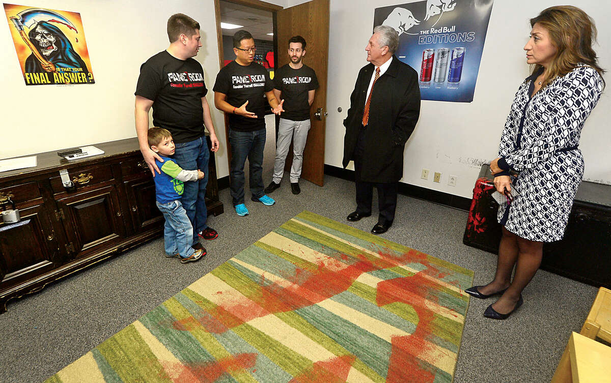 Hour photo / Erik Trautmann Panic Room founders, Justin Buturla, with his son Justin jr, Jack Yeung and Filipe Silva chat with Norwalk Mayor Harry Rilling and his wife, Lucia, during the mayor's small busniess spotlight visit.