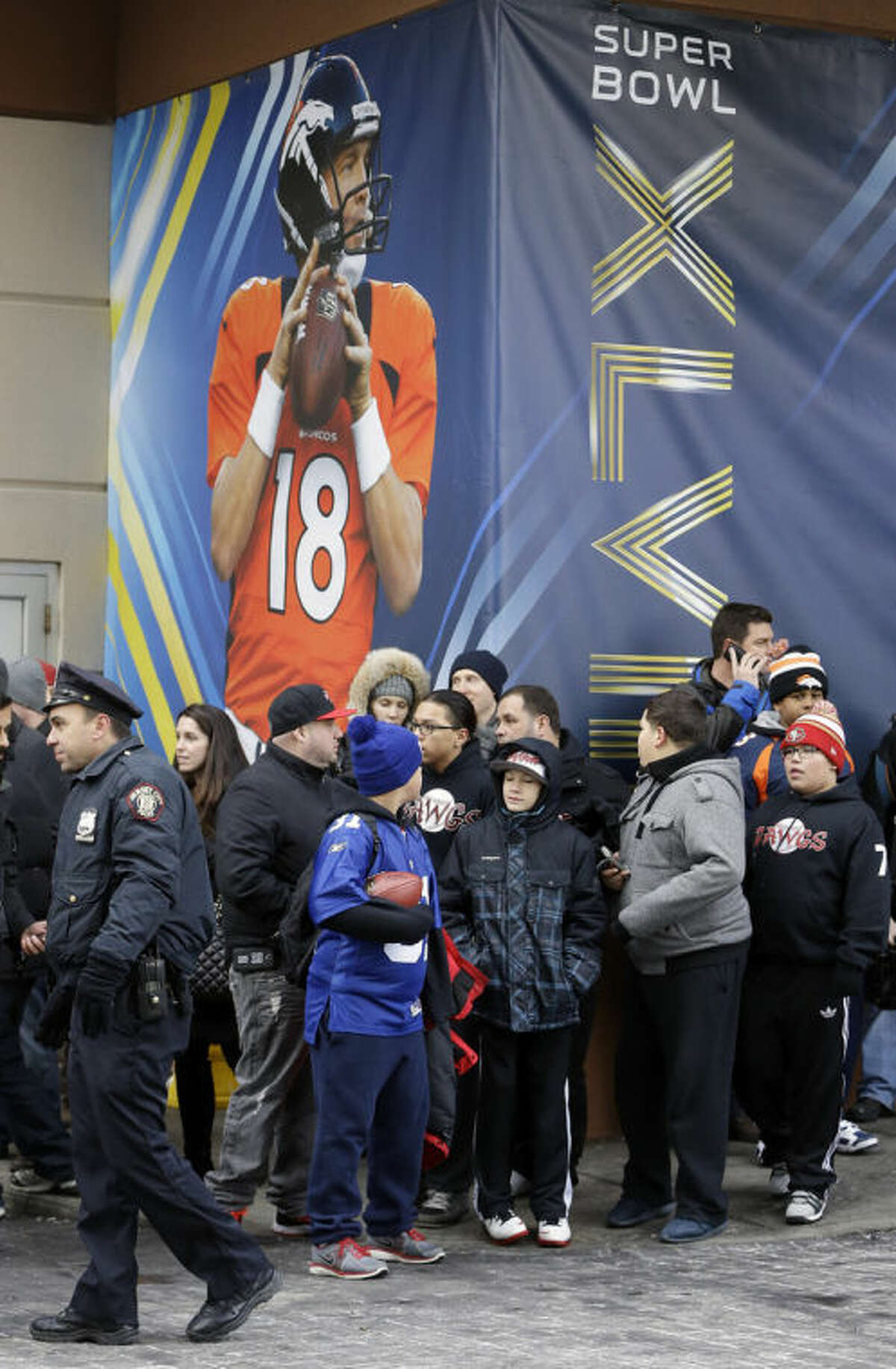 Denver Broncos fans wait for the Broncos' buses to arrive at the team hotel Sunday, Jan. 26, 2014, in Jersey City, N.J. The Broncos are scheduled to play the Seattle Seahawks in the NFL Super Bowl XLVIII football game Sunday, Feb. 2, in East Rutherford, N.J. (AP Photo/Mark Humphrey)