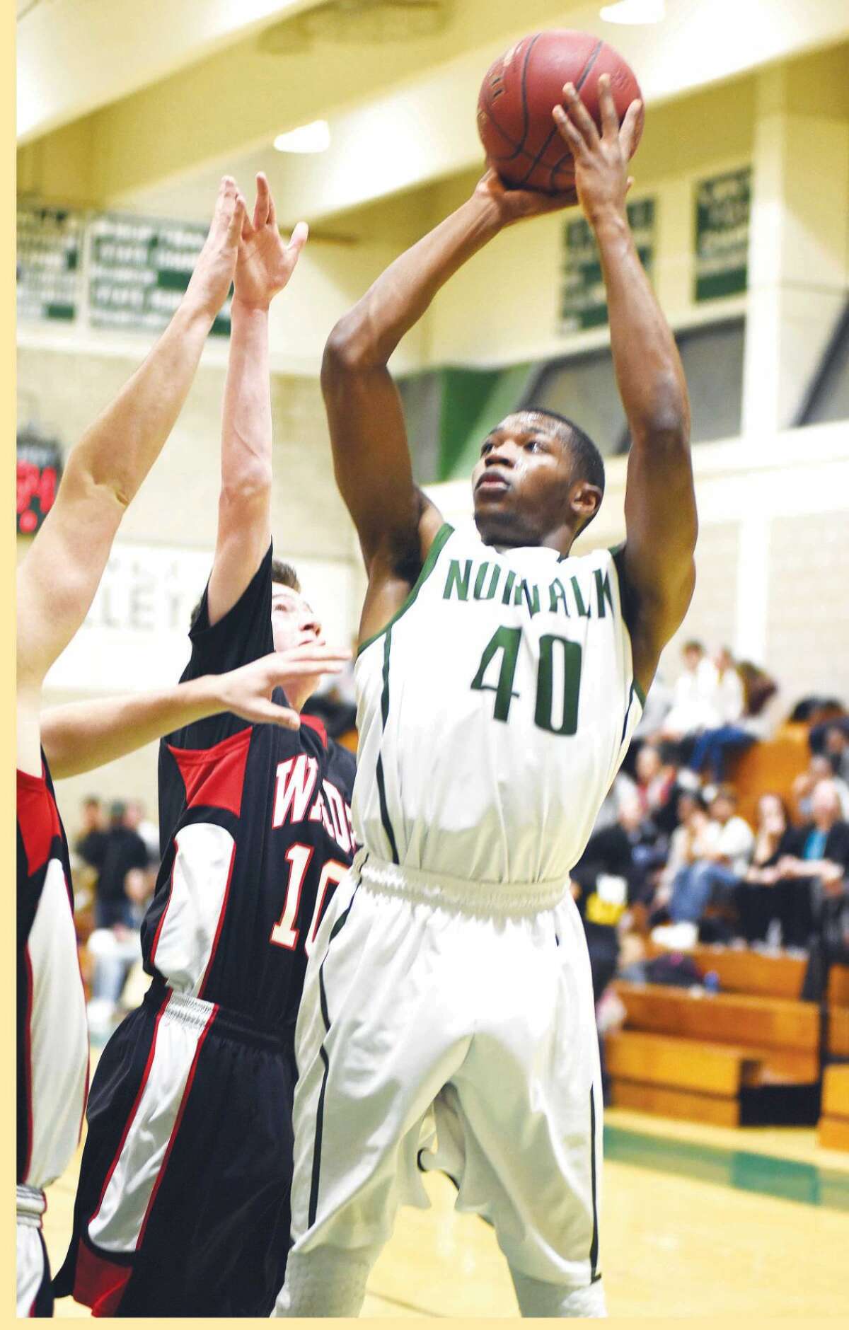 Hour photo/John Nash - Norwalk's Jakari Gainer (40) puts up a shot during Tuesday's game against Fairfield Warde.