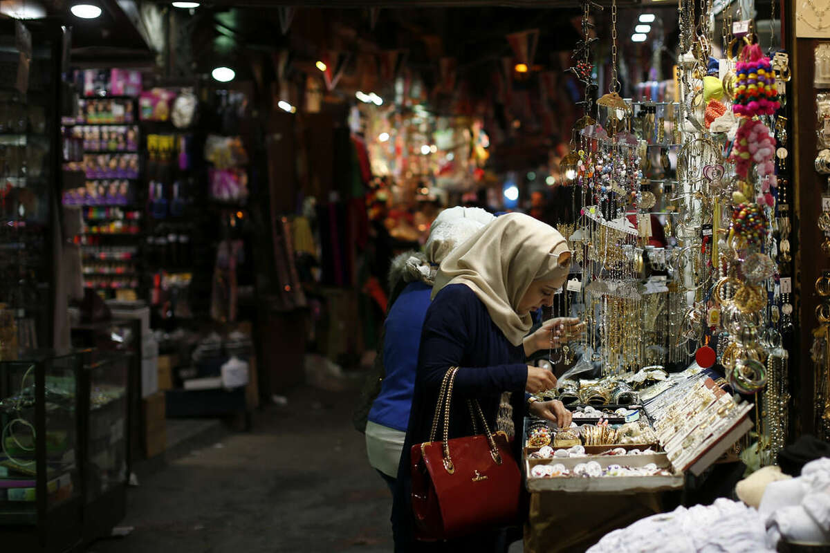 Syrian women shop at the popular Hamidiyeh old market in Damascus , Syria, Sunday, Feb. 21, 2016. (AP Photo/Hassan Ammar)