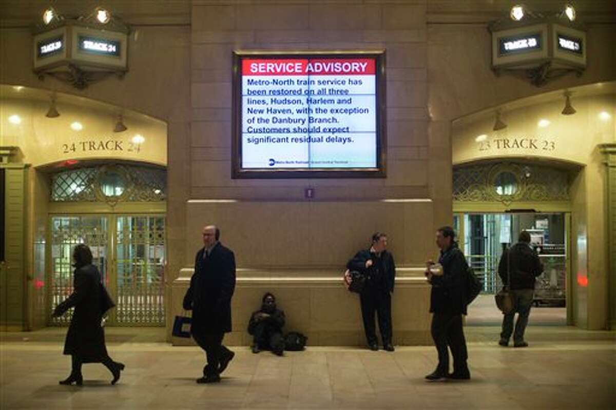 Commuters pass through the main hall of Grand Central Station as trains began resuming normal operation after a power problem with Metro-North Railroad's computer system caused the suspension of service on the Hudson, Harlem, and New Haven lines, Thursday, Jan. 23, 2014. Trains were brought to a halt for safety purposes while electricians worked to hook up temporary power to the computer system. Metro-North is the nation's second-busiest railroad and serves 281,000 riders a day in New York and Connecticut. 