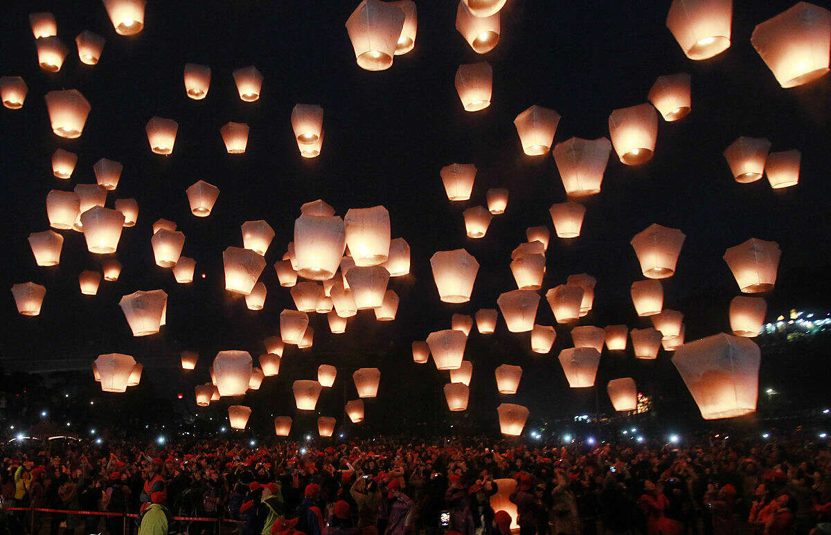 Hundreds of people release lanterns into the air in hopes of good fortune and prosperity at the traditional lantern festival during the Chinese New Year in the Pingxi district of New Taipei City, Taiwan, Monday, Feb. 22, 2016. The lantern festival starts 15 days after the Chinese Lunar New Year and falls on Feb. 22, this year. (AP Photo/Chiang Ying-ying)