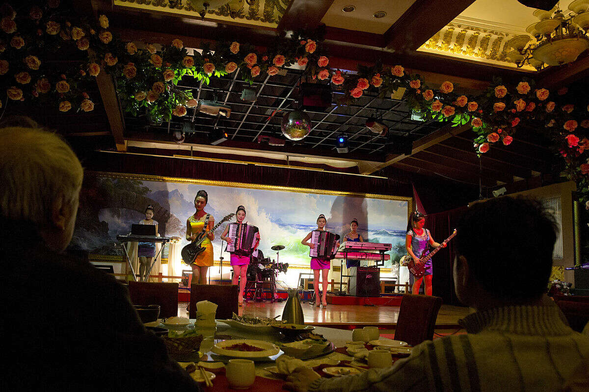 In this Feb. 18, 2016, photo, North Korean performers entertain customers at the Okryugwan restaurant in Beijing. Situated in the northeast corner of Beijing, the Okryugwan restaurant is feeling the far-flung effects of the latest standoff on the Korean peninsula. Since the North conducted a nuclear test in January and went ahead with a rocket launch earlier this month, Seoul has instructed its citizens to not patronize the government-affiliated North Korean restaurants that usually pull in a steady stream of curious South Korean travelers - and their precious foreign currency. (AP Photo/Ng Han Guan)