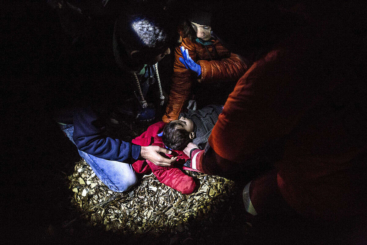 A volunteer doctor examines a Syrian child after his arrival with other refugees and migrants on a dinghy from the Turkish coast to the northeastern island of Lesbos, Monday, Feb. 22, 2016. European Union countries have sought to cap the influx of refugees after more than one million people entered in 2015. Nations along the entry route have agreed to jointly control the flow of migrants through their territories. (AP Photo/Manu Brabo)