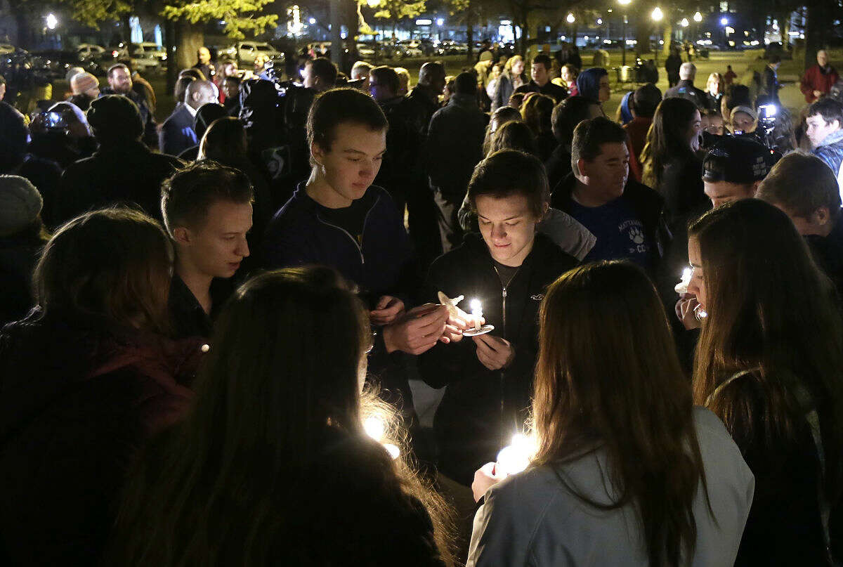 People gather in Bronson Park in Kalamazoo, Mich., Monday, Feb. 22, 2016, for a candlelight vigil for the victims of a series of random shootings in the Kalamazoo area over the weekend. Jason Dalton of Kalamazoo Township was charged with six counts of murder and two counts of attempted murder in the shootings and then arraigned on the charges. (AP Photo/Carlos Osorio)