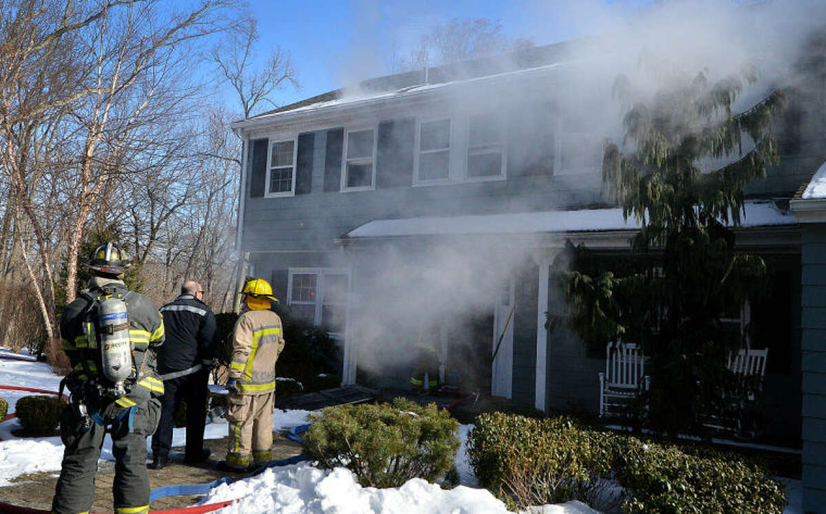 Smoke billows from a house on Valeview Road as Wilton Fire and emergency personnel respond on Tuesday morning.