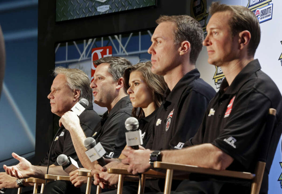 Driver/owner Tony Stewart, second from left, speaks as co-owner Gene Haas, left, and drivers, from right, Kurt Busch, Kevin Harvick and Danica Patrick listen during a news conference at the NASCAR Sprint Cup auto racing Media Tour in Charlotte, N.C., Monday, Jan. 27, 2014. (AP Photo/Chuck Burton)